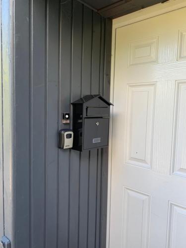 a safe is attached to a wall next to a door at Cedarbank’s - 'Little Art House' in Kirn