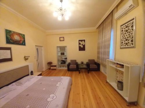 a bedroom with a bed and a living room at Yurd in Sheki in Sheki