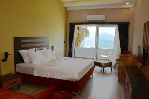 a bedroom with a bed with a view of the ocean at Villa Sevilla in Kusadası
