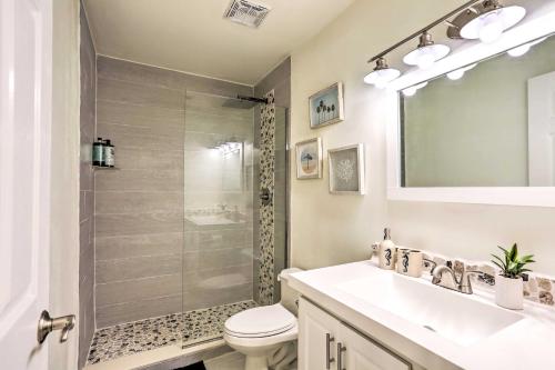 a bathroom with a shower and a toilet and a sink at Boat Owners Paradise Jensen Beach Home with Dock! in Jensen Beach