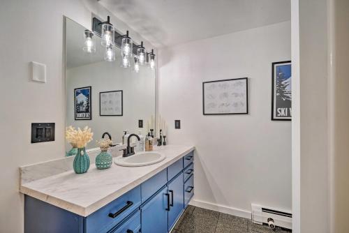 a bathroom with a sink and a mirror at Ski-InandSki-Out Magic Mountain Condo with Deck! in Londonderry