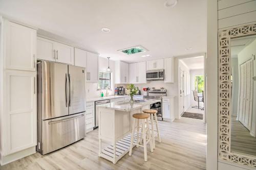 a kitchen with white cabinets and a stainless steel refrigerator at Riverside New Magnolia Springs Home with Dock, Beach in Foley
