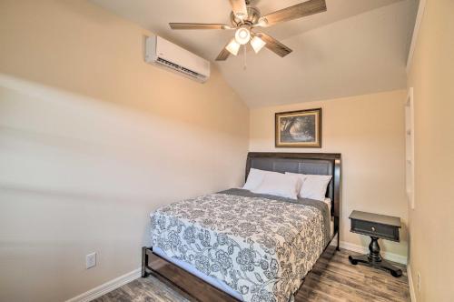 a bedroom with a bed and a ceiling fan at Stylish Woodville Cabin Fishing Dock Access! in Woodville