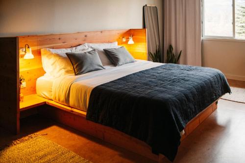 a bedroom with a large bed with a wooden headboard at Apres Whitefish in Whitefish