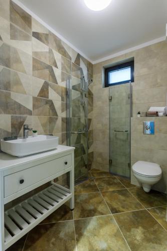 a bathroom with a sink and a toilet and a shower at Kraimorie Park in Burgas