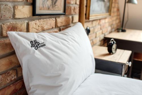 a white pillow sitting on top of a brick wall at Loftlakásom**** in Veszprém