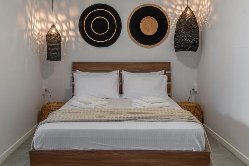 a bedroom with a bed with two hats on the wall at Irida in Preveza