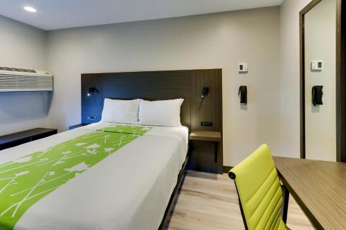 a bedroom with a large bed and a desk at The Shamrock in Cicero