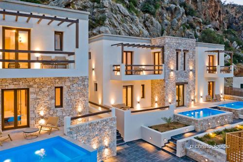 a villa with two pools in front of it at Ypsilos Beach Suites in Kyra Panagia