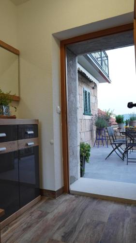 a kitchen with a door open to a patio at Apartmani Tripalo in Imotski