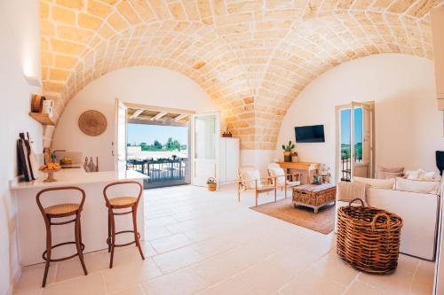 a kitchen and living room with a stone wall at Masseria Macchiaforte in Gallipoli