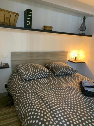 a bedroom with a large bed with two pillows at Studio de Nini in Rousson