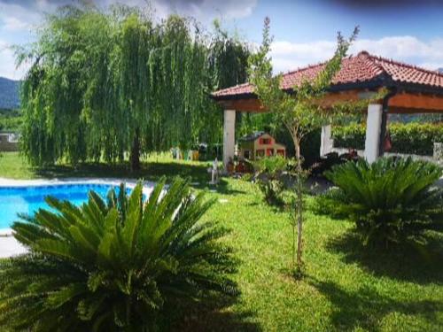 a garden with a pavilion and a swimming pool at Villa Fabry in Ploče