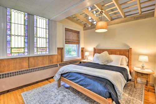 a bedroom with a bed and a stained glass window at Lisle Apt Fireplace and Stained Glass Windows! in Lisle