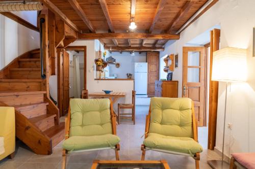 a living room with two chairs and a table at Stone House in Lafkos Pelion in Lafkos
