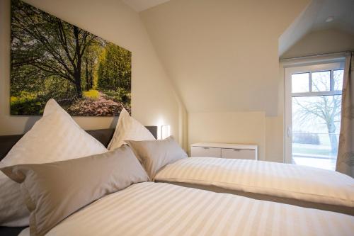 a bedroom with two beds and a painting on the wall at Hanses Hof in Brilon