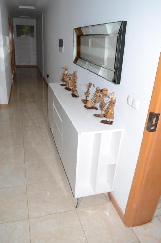 a white cabinet with figurines on top of it at La Terraça in Praia