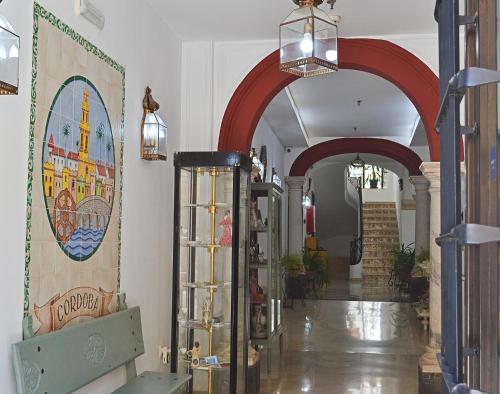 a hallway with red arches in a store at Hotel Marisa in Córdoba