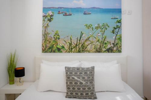 a bedroom with a bed with a painting on the wall at Daniel's garden apartment in Eilat