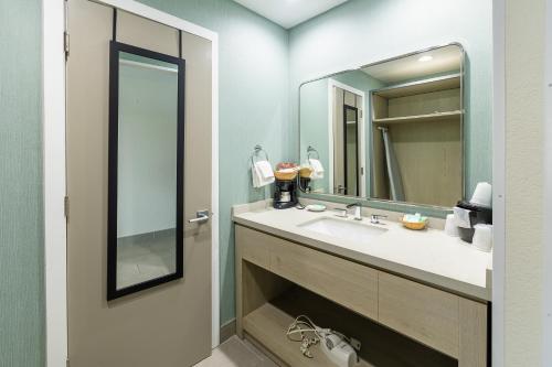 a bathroom with a sink and a mirror at Jot's Resort in Gold Beach