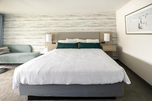 a bedroom with a large white bed and a couch at Jot's Resort in Gold Beach