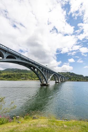 a bridge over a river with a train on it at Jot's Resort in Gold Beach