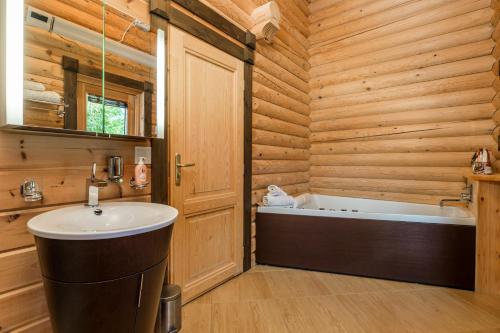 a bathroom with a sink and a bath tub at Holiday House Abies in Ravna Gora