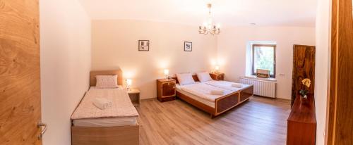 a bedroom with two beds and a window at House Hiperbola & Outdoor Activities in Bovec
