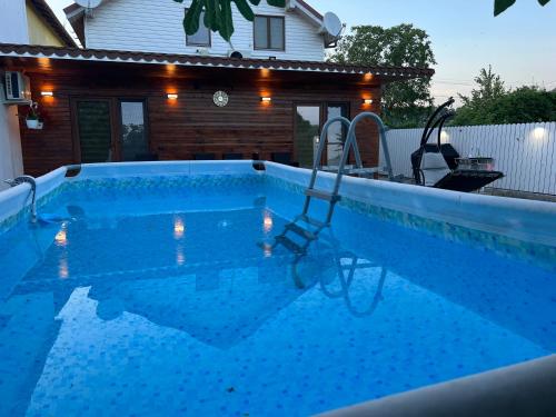 a swimming pool with a swing in front of a house at La Samba in Crisan