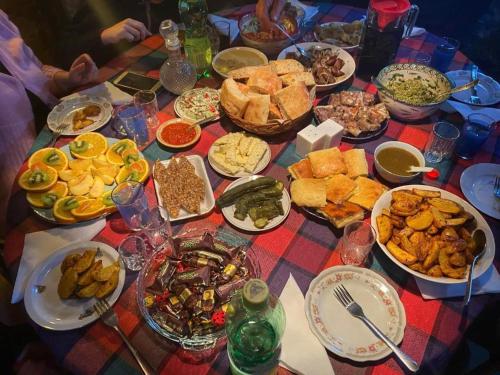 a table with many plates of food on it at Artist's House in Tʼetʼri Tsqaro