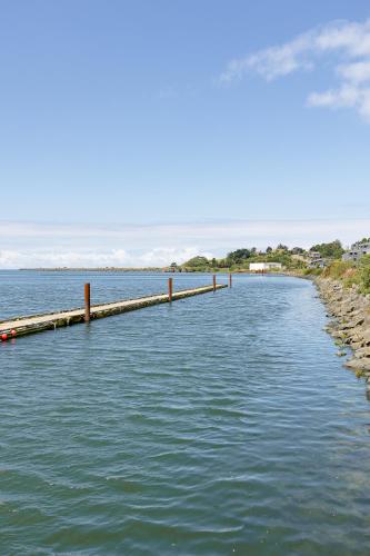 a long pier stretches out into the water at Jot's Resort in Gold Beach