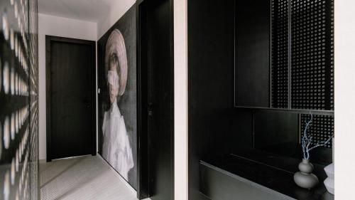 a black kitchen with a picture of a woman on the wall at Villa Domina by Villas Holiday in Srima