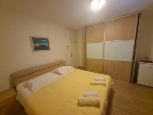a bedroom with a bed with two towels on it at Rooms Anđelka in Bol