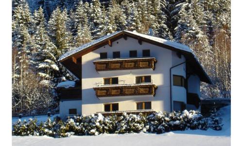 a building in the snow with snow covered trees at Ursula Maria in Ischgl