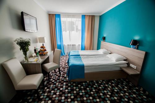 Optima Rivne tesisinde bir odada yatak veya yataklar