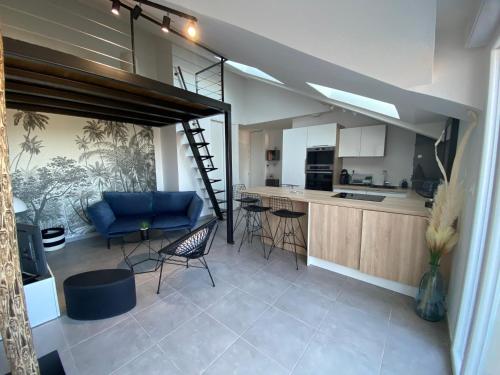 a kitchen and a living room with a loft at Appart & Fleurinoise balcon ascenseur climatisation in Fleurieux-sur-lʼArbresle