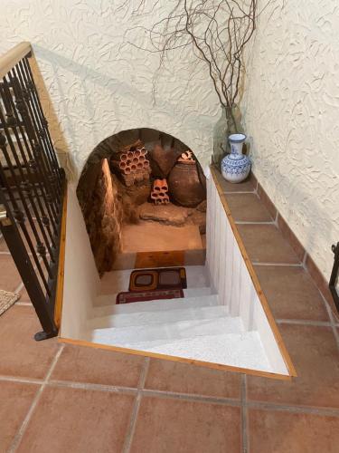 a small fireplace in a house with a staircase at Casa Artista in Pedro Bernardo
