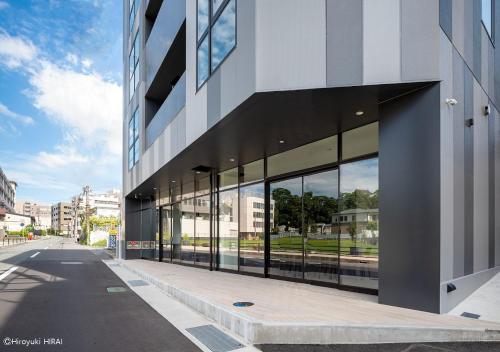 a building with large glass windows on a street at THE VIEW Odawara shiro-no mieru hotel - Vacation STAY 67008v in Odawara