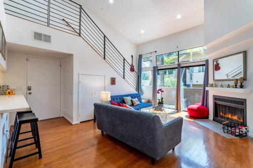 a living room with a couch and a fireplace at Franklin Loft Walk to Hollywood Bowl in Los Angeles