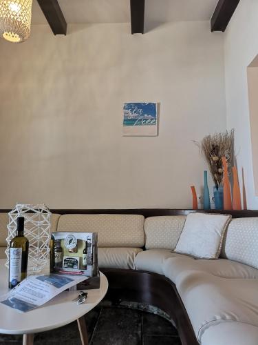 a living room with a couch and a table at Relax Seaside House by living in blue in Haraki
