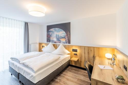 Säng eller sängar i ett rum på Akzent Hotel Hoyerswege