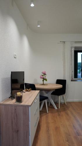 a kitchen with a table and a table and chairs at Apartmani Tripalo in Imotski