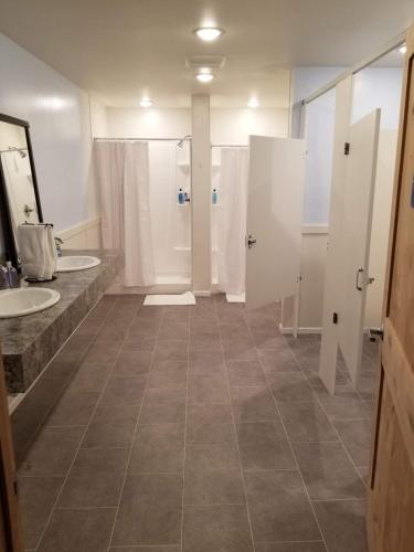 a large bathroom with two sinks and two toilets at The Abbey in Leadville
