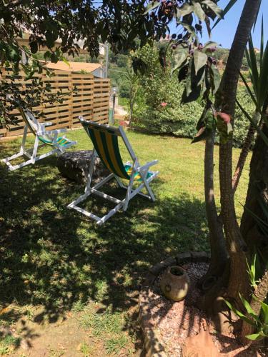 two lawn chairs sitting in the shade of a tree at Casanostra in San Vito Chietino