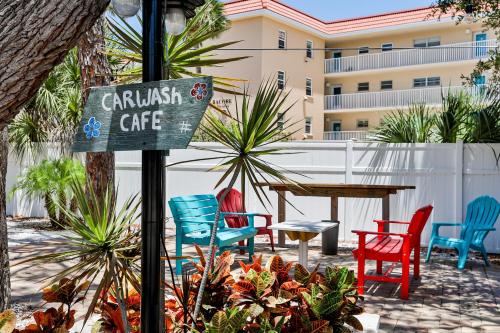a sign for a cafe with colorful chairs and a table at Midnight Cove II 823 in Siesta Key