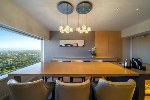 a dining room with a large wooden table and chairs at Hyatt Regency Mexico City in Mexico City