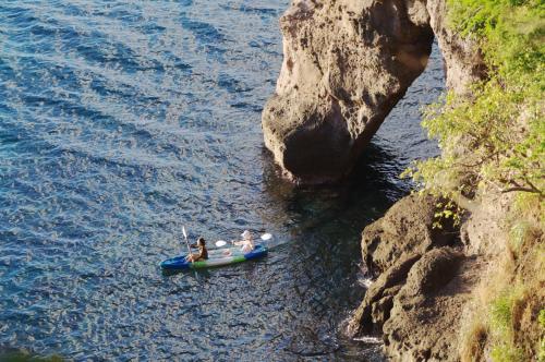 two people in a kayak in the water near a cliff at Secret Bay in Portsmouth