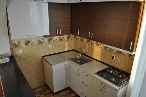a kitchen with a sink and a counter top at Akhmed Guest House in Kvariati