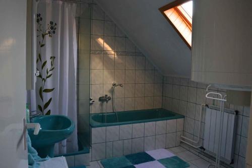 a bathroom with a bath tub and a sink at Apartment Gyenesdias 18 in Gyenesdiás