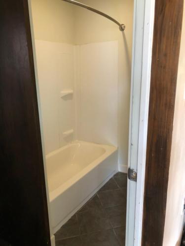 a white bath tub in a bathroom with a tile floor at 1/F 2 bed rooms in Pittsburgh